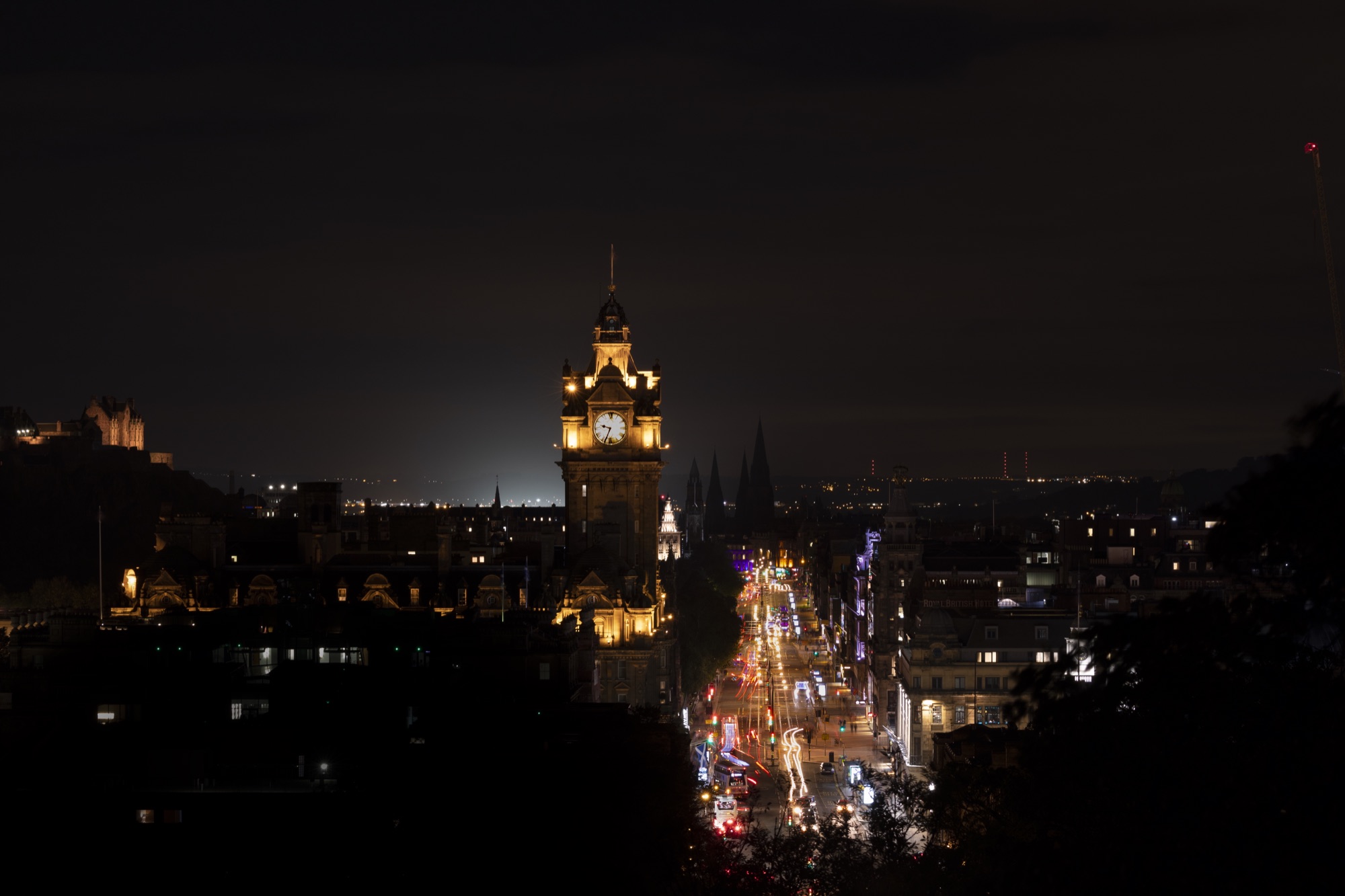 Edinburgh at night with the illuminated Balmoral clock tower, photographed by Matt McLeary